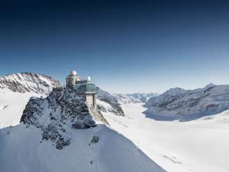 Aerial view of the Jungfraujoch in winter. In the background, the Aletsch Glacier can be seen alongside the mountain panorama.