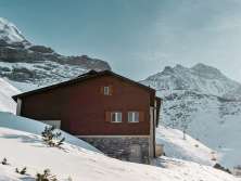 Winter in Grindelwald: A cabin and chairlift in front of the Eiger.