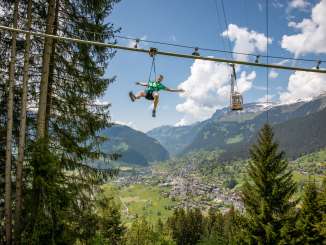 Pfingstegg Fly Line with one person. Grindelwald and the gondola in the background.